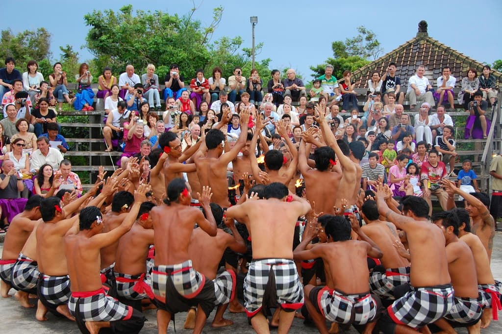 Performers seated in a circle around a fire during a Balinese Kecak dance