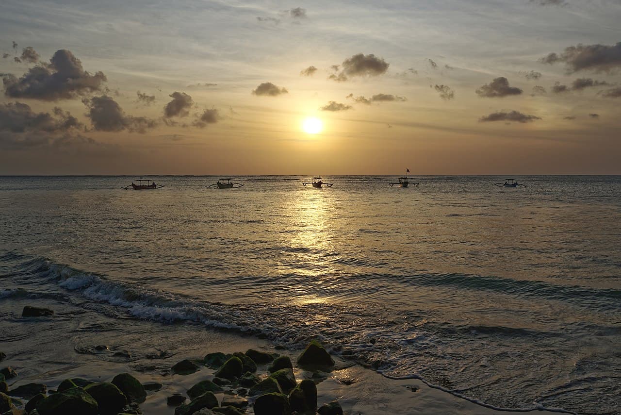 Travellers watching the sunset on a Bali beach