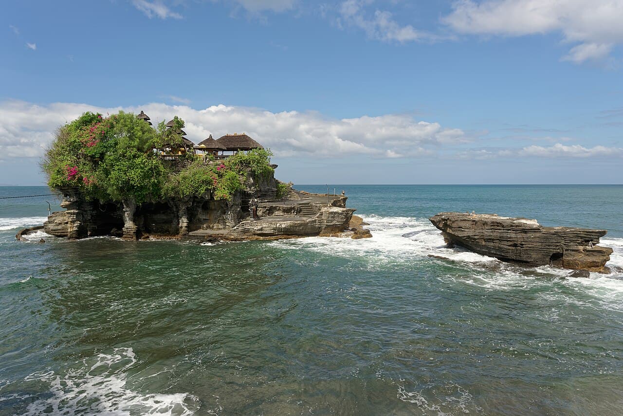 Tanah Lot temple on a rock formation surrounded by the sea at dusk, Bali