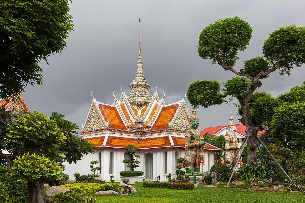 The prang spires of Wat Arun rising above the Chao Phraya River in Bangkok