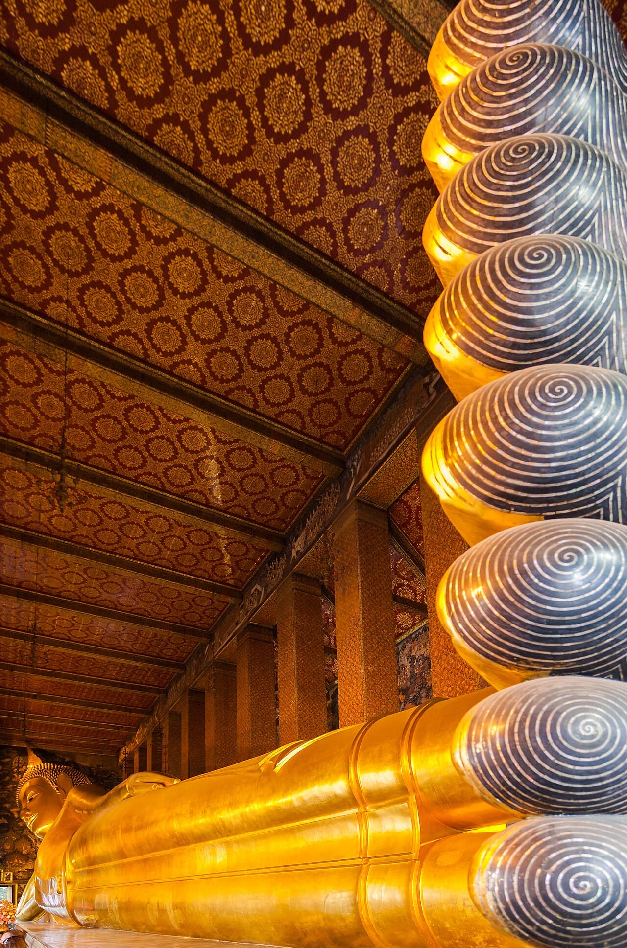 The vast golden Reclining Buddha inside Wat Pho, Bangkok