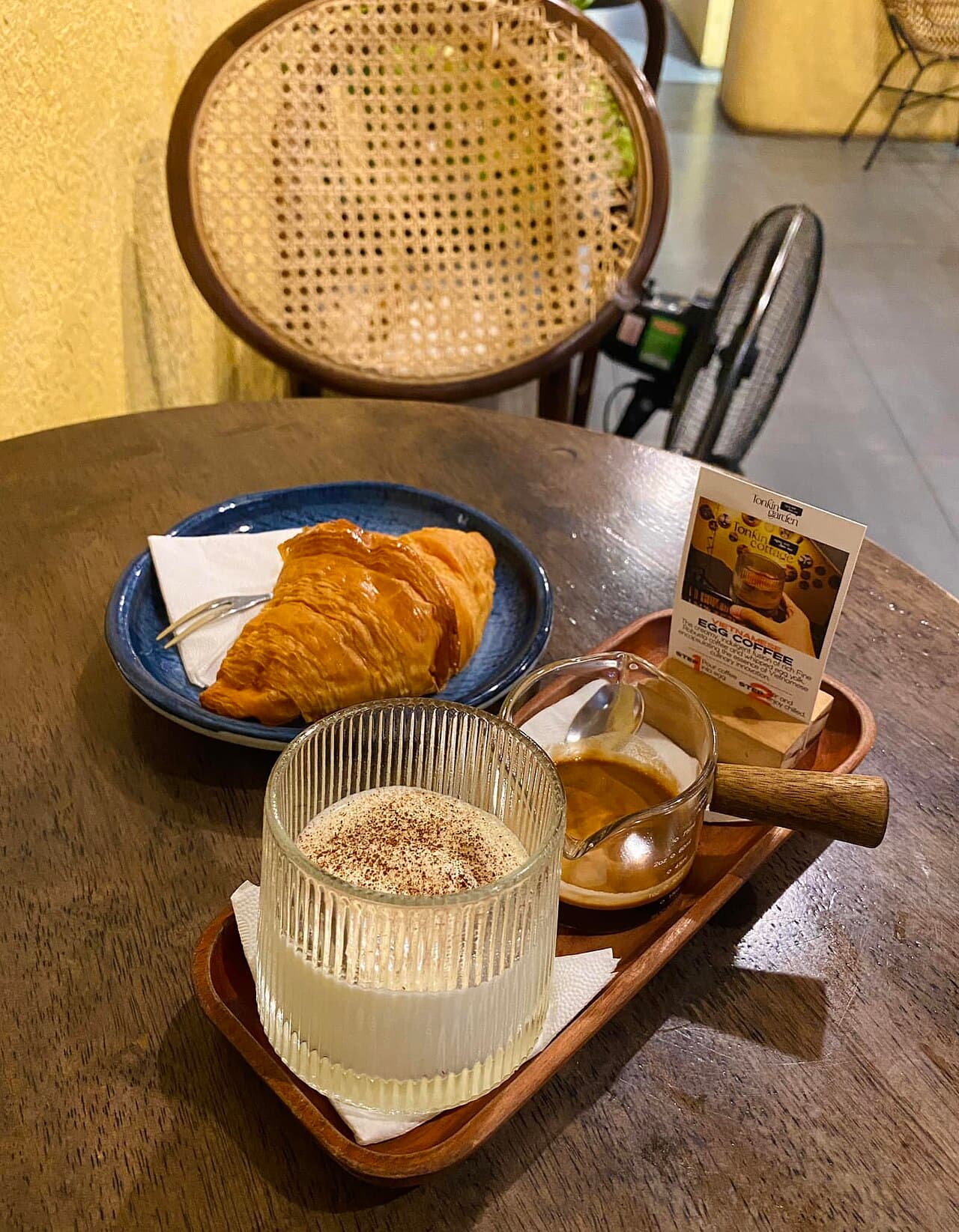 A glass of Vietnamese egg coffee topped with whipped egg-yolk cream