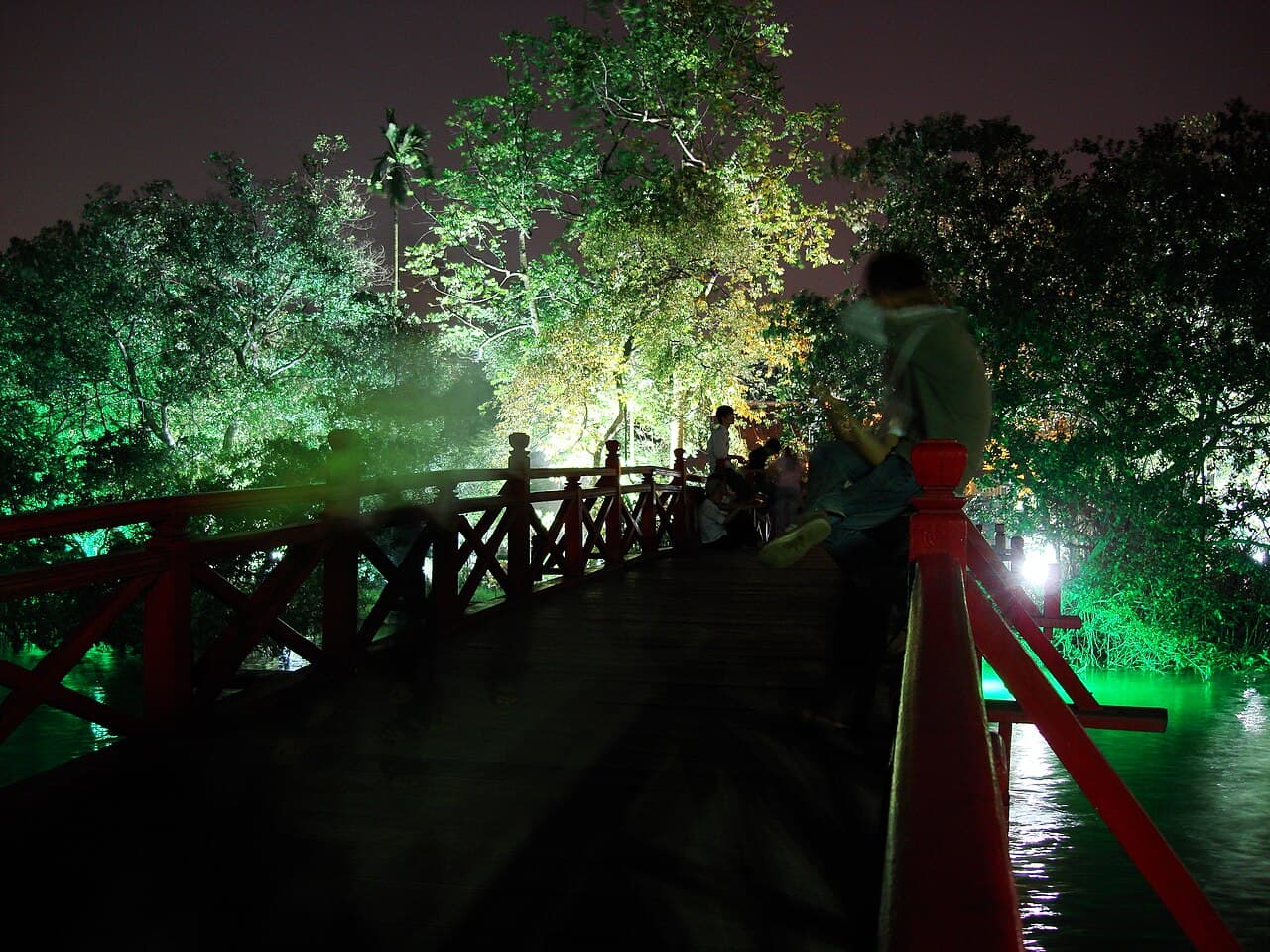 The red Huc Bridge crossing to Ngoc Son Temple on Hoan Kiem Lake, Hanoi