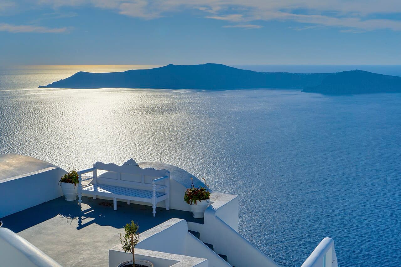 Whitewashed cliffside village above the sea at golden hour